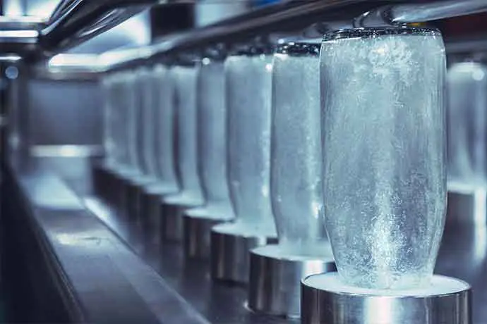 Row of glass bottles on a production line in a factory setting