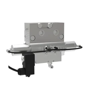 The image features a silver mechanical device that appears to be a valve or actuator. It has a rectangular body with several circular openings and a cylindrical component extending from its side. A black cable is connected to the base of the device, and t