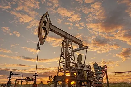 Petroleum concept. Oil pump rig. Oil and gas production. Oilfield site. Pump Jack are running.